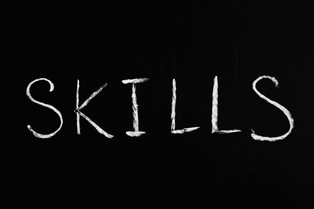 Chalk lettering of the word 'skills' on a blackboard, emphasizing learning and education.